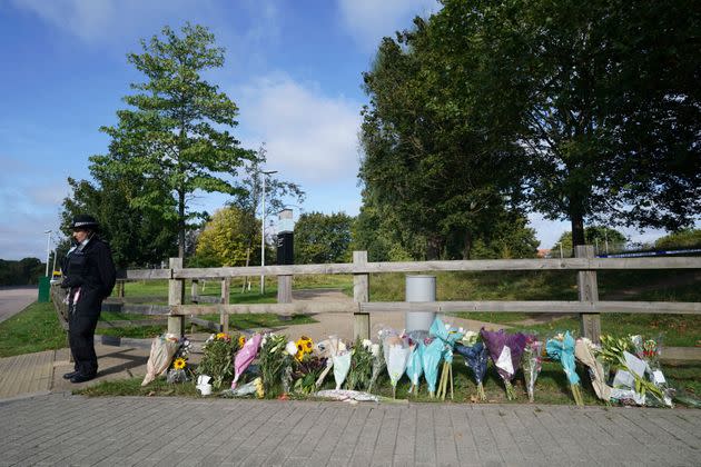 A police officer stands by floral tributes at Cator Park in Kidbrooke, near to the area where the body of Sabina Nessa was found. (Photo: via Associated Press)