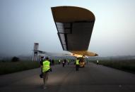 The Solar Impulse aircraft is pulled out of the hangar for take off at Payerne airport in Switzerland, May 24, 2012. The Solar Impulse HB-SIA prototype aircraft, which has 12,000 solar cells built into its 193 foot wings, will attempt a round-the-world flight in 2014. REUTERS/Denis Balibouse