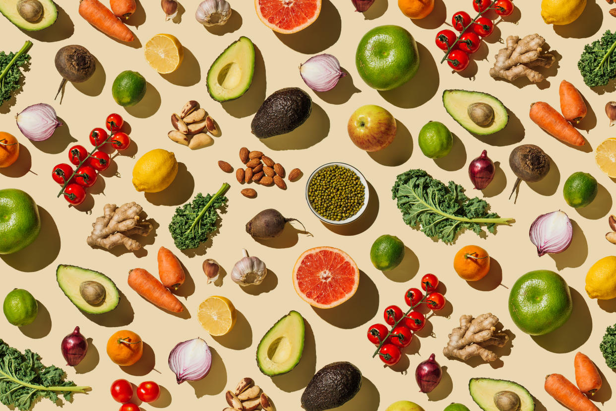 Pattern of variety fresh of organic fruits and vegetables and healthy vegan meal ingredients on beige background. Healthy food, clean eating, diet and detox, eco friendly, no plastic concept. Flat lay, top view