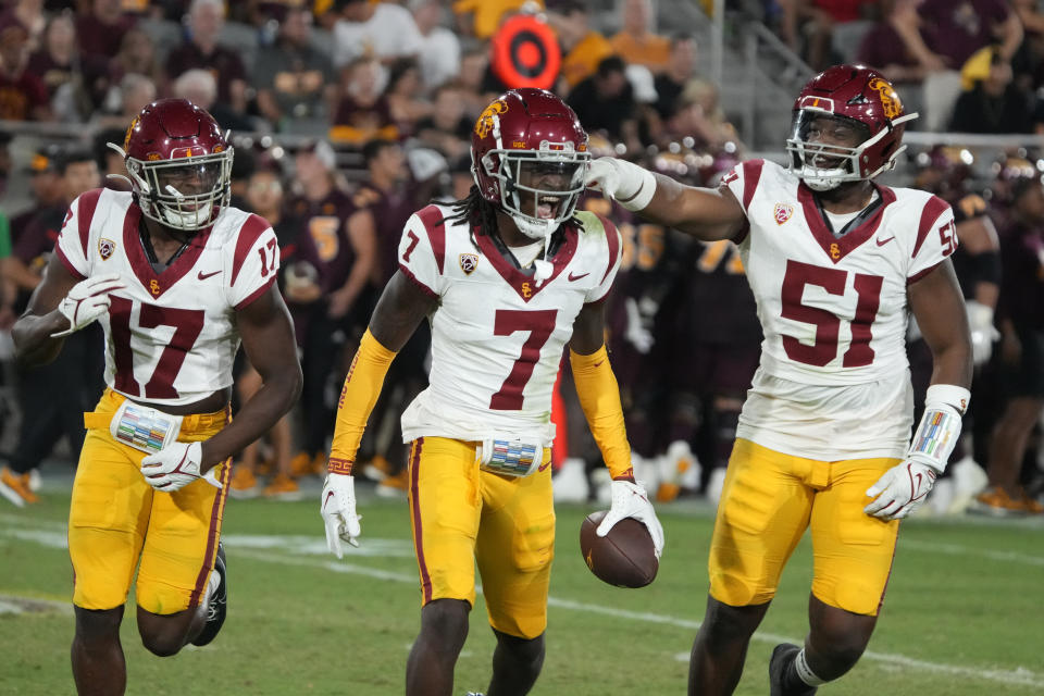 Southern California safety Calen Bullock (7) celebrates with cornerback Christian Roland-Wallace (17) and defensive end Solomon Byrd after intercepting the ball against Arizona State in the second half during an NCAA college football game, Saturday, Sept. 23, 2023, in Tempe, Ariz. Southern California won 42-28. (AP Photo/Rick Scuteri)