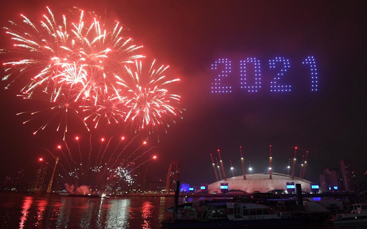 Fireworks and drones illuminate the night sky over the The O2 in London 