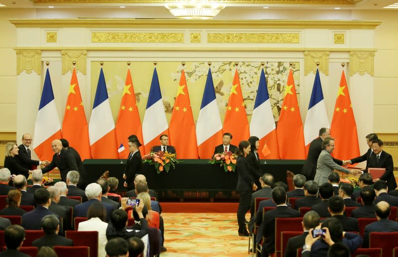 China's President Xi Jinping and French President Emmanuel Macron attend a signing ceremony in Beijing