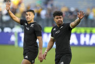 New Zealand's Rieko Ioane, left, and Ardie Savea wave to the crowd following the Rugby Championship game between the All Blacks and the Wallabies in Perth, Australia, Sunday, Sept. 5, 2021. (AP Photo/Gary Day)