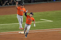 Houston Astros' Alex Bregman (2) celebrates after hitting a home run against the Texas Rangers during the first inning in Game 5 of the baseball American League Championship Series Friday, Oct. 20, 2023, in Arlington, Texas. (AP Photo/Tony Gutierrez)