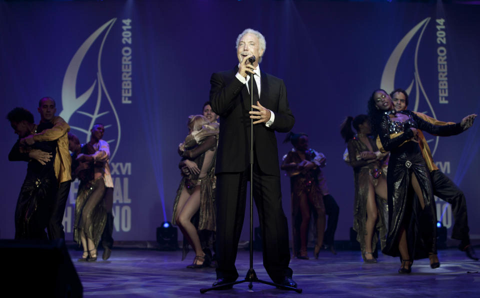 Welsh crooner Tom Jones performs during a gala dinner marking the end of the 16th annual Cigar Festival in Havana, Cuba, Friday, Feb. 28, 2014. The festival is a five-day bash that brings together hundreds of cigar sophisticates from around the world, and culminates with a gala and auction of humidors worth hundreds of thousands of dollars. Tom Jones was among the celebrity invitees at Saturday's auction and sang three songs for attending guests, including his signature "It's Not Unusual." (AP Photo/Franklin Reyes)