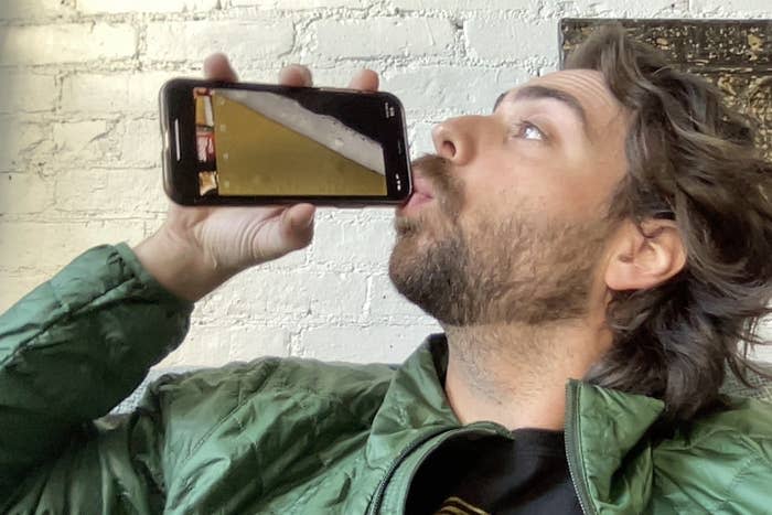 a man drinking out of a fake beer app
