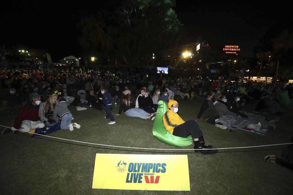 People gather Wednesday, July 21 , 2021, in Brisbane, Australia, for the announcement by the International Olympic Committee (IOC) on 2032 Summer Olympics bid. The Australian city was the inevitable winner of a one-candidate race steered by the IOC to avoid rival bids. (Jason O'Brien/AAP Image via AP)