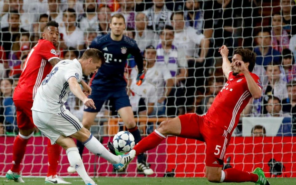 Real Madrid's German midfielder Toni Kroos (2L) tries to score next to defender Mats Hummels  - Credit: EFE