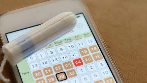 PHOTO: Period tracker app on a smart phone with a tampon. (STOCK PHOTO/Getty Images)