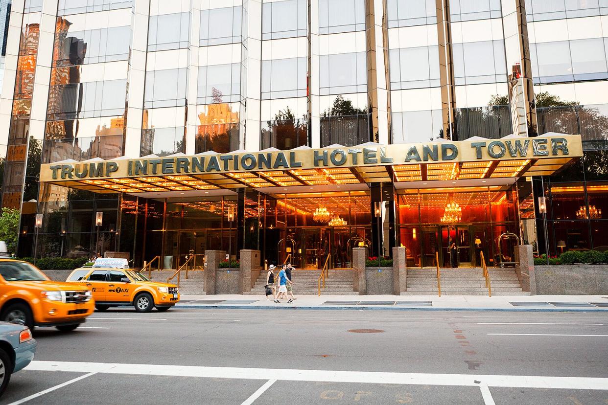 Trump International Hotel and Tower on Central Park West above Columbus Circle. Taxis and people can be seen.