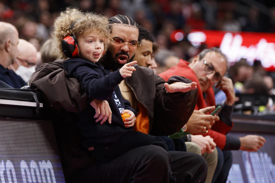 TORONTO, ON - APRIL 28:  Rapper Drake and his son Adonis take in the Game Six of the Eastern Conference First Round between the Toronto Raptors and the Philadelphia 76ers at Scotiabank Arena on April 28, 2022 in Toronto, Canada. NOTE TO USER: User expressly acknowledges and agrees that, by downloading and or using this Photograph, user is consenting to the terms and conditions of the Getty Images License Agreement. (Photo by Cole Burston/Getty Images)