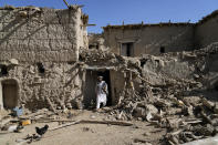 A man walks out of his damaged house after an earthquake in Gayan village, in Paktika province, Afghanistan, Friday, June 24, 2022. A powerful earthquake struck a rugged, mountainous region of eastern Afghanistan early Wednesday, flattening stone and mud-brick homes in the country's deadliest quake in two decades, the state-run news agency reported. (AP Photo/Ebrahim Nooroozi)