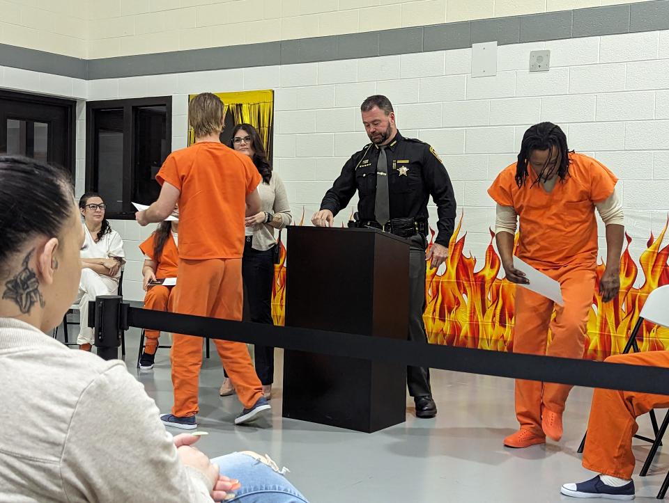 Diplomas are handed out to inmates by Sandusky County Sheriff Chris Hilton at the Sandusky County I.G.N.I.T.E. graduation March 20.