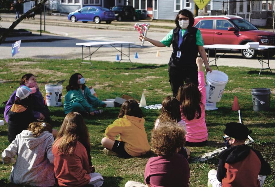 Indra Edmonds, a 1st Grade teacher at the Maple Street Magnet School, explains to 5th graders the design for their Sea Perch remotely operated vehicle competition last spring. The magnet school, a project-based learning community with a theme of community and sustainability, works to bring hands-on learning to life using outdoor learning spaces.