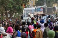 Wild cheers and singing broke out as Pope Francis arrived at the open air shrine where over 100,000 people had waited from before dawn to attend mass, a key highlight of his visit to Uganda