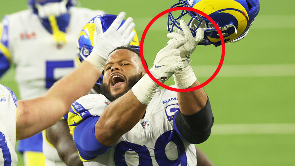 Pictured here, Aaron Donald gestures towards his ring finger after a massive late defensive play sealed the Rams' Super Bowl win.