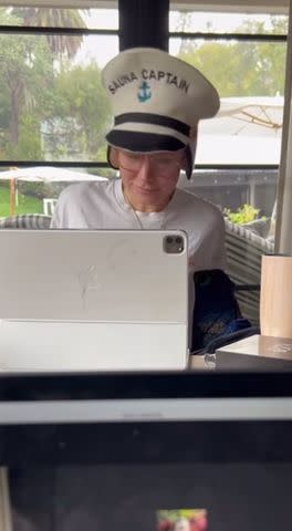 <p>Kristen Bell/Instagram</p> Bell wearing a hat that says "Sauna Captain" on it during a work call.