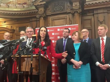 FILE PHOTO: Jacinda Ardern (C), New Zealand's new opposition Labour leader, speaks to the press alongside members of her party after Andrew Little stepped down in Wellington, New Zealand, August 1, 2017. REUTERS/Charlotte Greenfield/File Photo