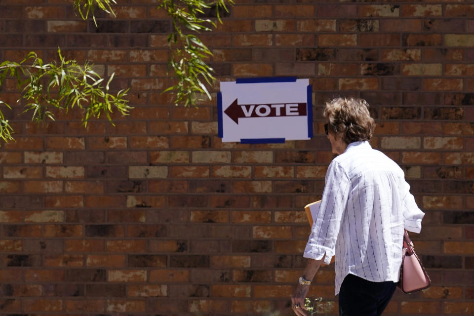 A voter heads into a polling stating as Arizona voters go the polls to cast their ballots, Tuesday, Aug. 2, 2022, in Tempe, Ariz. (AP Photo/Ross D. Franklin)