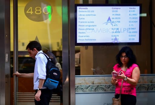 Currency exchange values are displayed on the buy-sell board of an exchange bureau in Buenos Aires; Argentina's peso rose more than 3 percent against the dollar after the October 27, 2019 victory of presidential candidate Alberto Fernandez