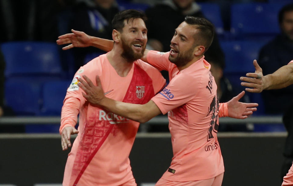 FC Barcelona's Lionel Messi, left, celebrates with a teammate during the Spanish La Liga soccer match between Espanyol and FC Barcelona at RCDE stadium in Cornella Llobregat, Spain, Saturday, Dec. 8, 2018. (AP Photo/Joan Monfort)