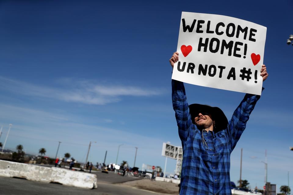 Eric Drake welcomes the Grand Princess cruise ship at the port in Oakland, Calif., on March 9.