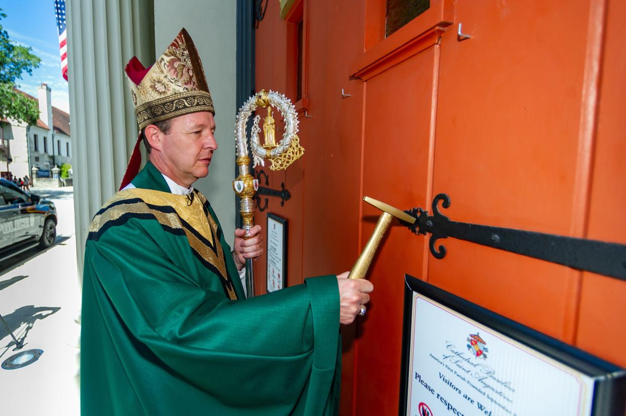 On July 24, 2022, Rev. Erik Pohlmeier, the newly-installed 11th Bishop of the Diocese of St. Augustine, knocks to be admitted to his new church home, the Cathedral Basilica of St. Augustine, to celebrate his first Mass there. A reception at The Treasury on the Plaza followed the service.