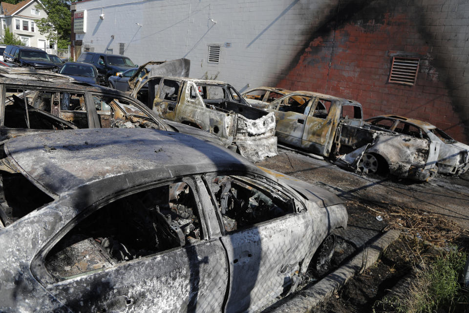 A parking lot filled with scorched cars is seen Saturday, May 30, 2020, after a night of fires and looting in Minneapolis. Protests continued following the death of George Floyd, who died after being restrained by Minneapolis police officers on Memorial Day. (AP Photo/Julio Cortez)