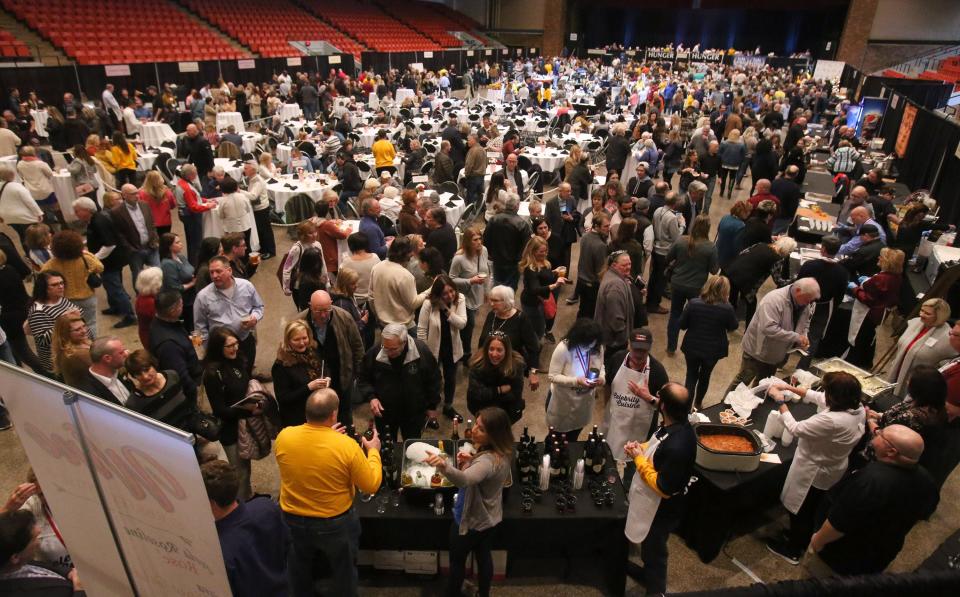 People pack the floor for Celebrity Cuisine at the Canton Memorial Civic Center on Tuesday.  Hosted by Atlantic Food Distributors and the Tri-County Restaurant Association, the event benefited Community Harvest, a hunger-relief program of Akron-Canton Regional Foodbank.