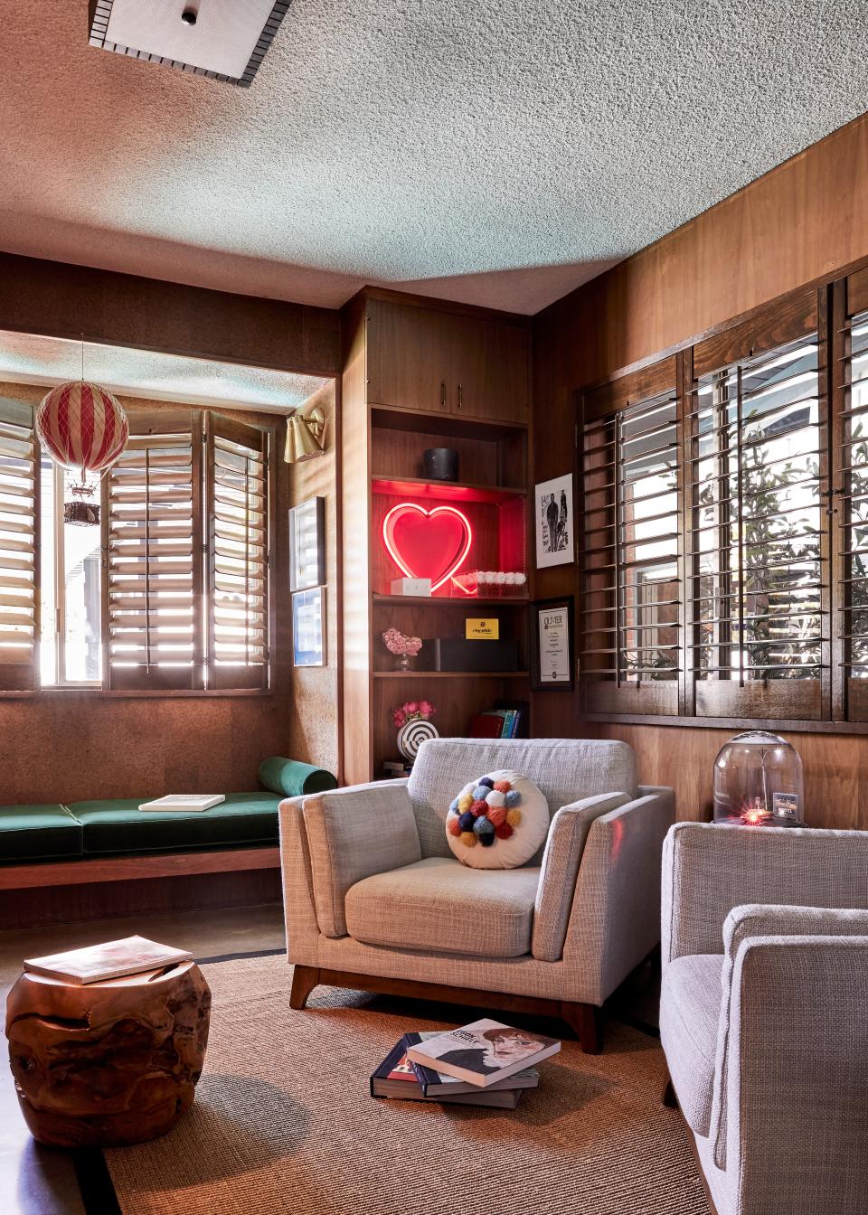 “We wanted it all to feel like Alice in Wonderland," Colman says. And a wonderland they did create. In Colman’s home office, there’s a hot air ballon and neon lights that contrast with down-to-earth Article seating and warm tones.