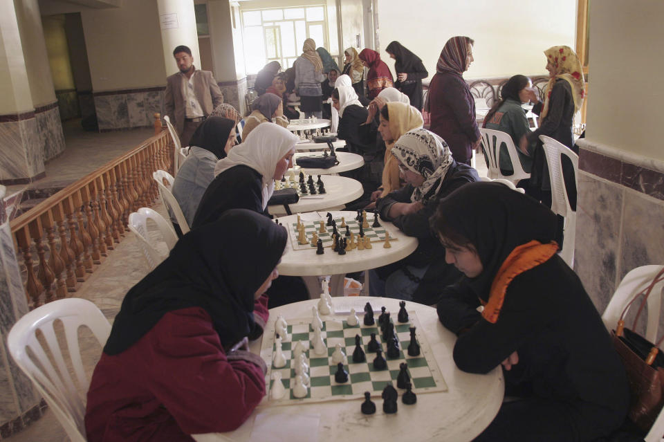 Afghan high school girls play chess during a tournament in Herat province, southwest of Kabul, Afghanistan on Saturday, Nov. 3, 2007. Schools for girls from grades 7 to 12 have reopened in Afghanistan's third largest city, Herat, residents said Monday, Nov. 8, 2021 in what appeared to be a localized change in the Taliban's bar on classes for girls of that age. (AP Photo/Fraidoon Pooyaa, file)