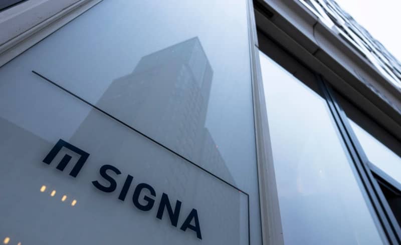 The logo of the real estate company Signa is displayed on the facade of a high-rise building at the company's Berlin headquarters. The public prosecutor's office in the southern German city of Munich is investigating suspicions of money laundering at the insolvent Signa Group owned by Austrian entrepreneur René Benko, a spokeswoman told dpa on Wednesday. Monika Skolimowska/dpa