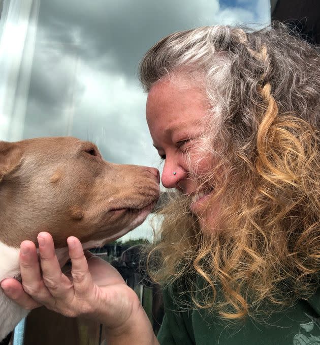 "Here I am growing out my gray and smooching my special needs rescue pup, Sissy," the author writes. <span class="copyright">Courtesy of Katrina Anne Willis</span>