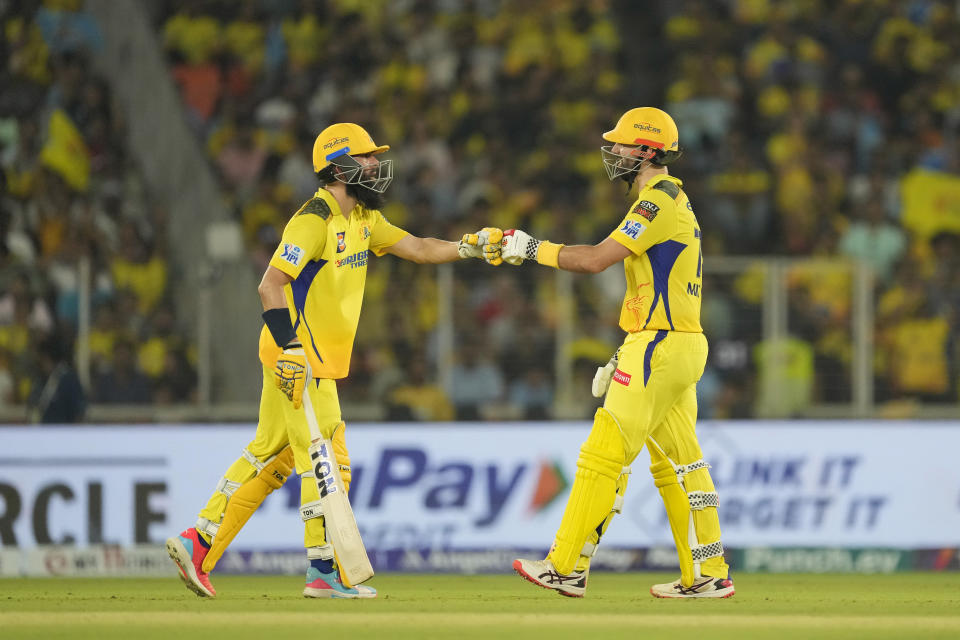 Chennai Super Kings' Daryl Mitchell, right, is congratulated by teammate Moeen Ali for completing his fifty runs during the Indian Premier League cricket match between Chennai Super Kings and Gujarat Titans in Ahmedabad, India, Friday, May 10, 2024. (AP Photo /Ajit Solanki)