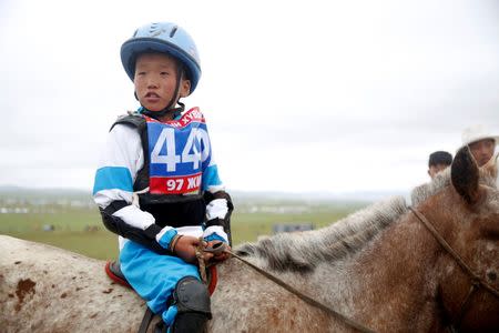 Child jockey Bat-Erdene, 11, is seen on his horse at the Mongolian traditional Naadam festival, on the outskirts of Ulaanbaatar, Mongolia July 11, 2018. Picture taken July 11, 2018. REUTERS/B. Rentsendorj