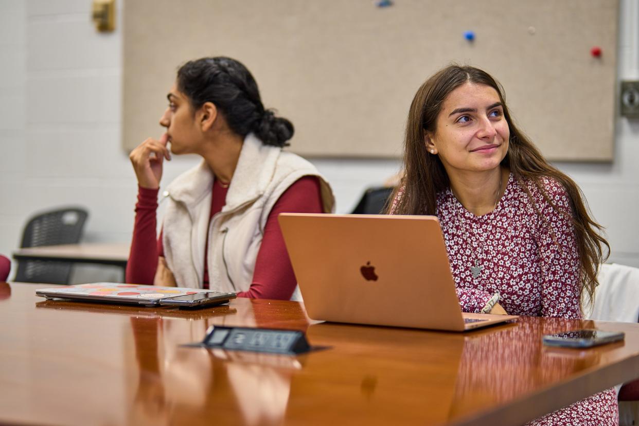 Rachael Perrotta, right, looks up from her computer during class.