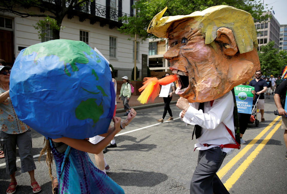 Protesters dressed as the Earth and President Donald Trump pretend to fight during the People's Climate March near the White House in April 2017. (Photo: Joshua Roberts / Reuters)