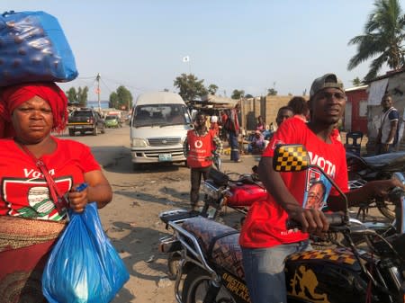 People dressed in t-shirts of the ruling Frelimo party are seen at a market in Beira