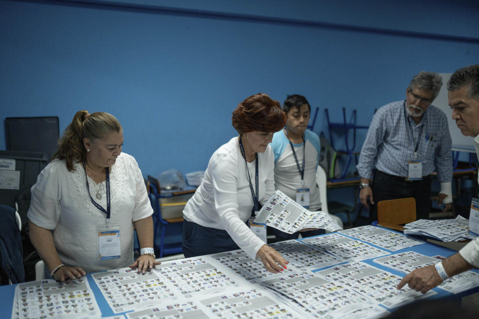 Electoral workers count ballots after the polls closed during general elections in Guatemala City, Sunday, June 25, 2023. (AP Photo/Santiago Billy)