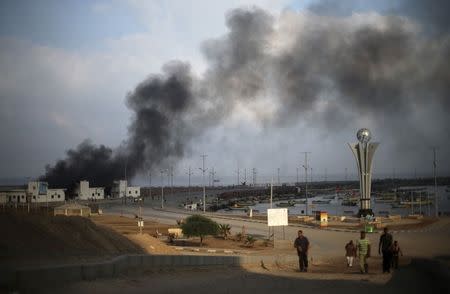 Smoke rises at the Seaport of Gaza City following what witnesses said was a shelling by the Israeli Navy July 29, 2014. REUTERS/Mohammed Salem