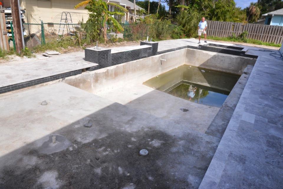 Cocoa Beach resident Patrick Lee stands with his unfinished swimming pool. He claims in a lawsuit that he paid $92,276 to Legacy Pools in three installments during 2021 to build him the pool, but the company never finished the work. He has since hired another company to complete the job.