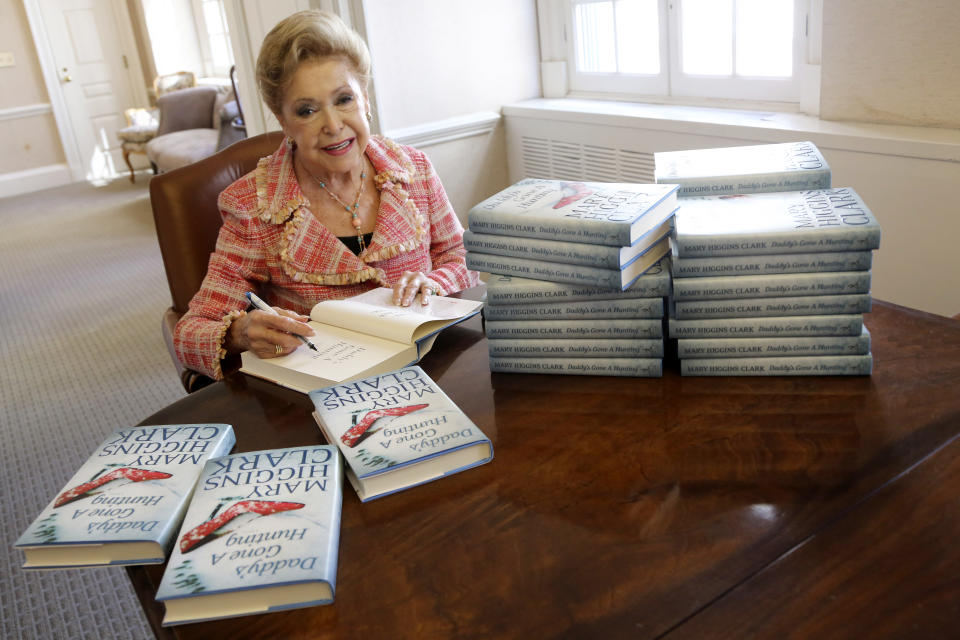 FILE - In this April 3 2013, file photo, author Mary Higgins Clark sign copies of her latest book "Daddy's Gone A Hunting" at the Simon & Schuster office in New York. Clark, 92, was the tireless and long-reigning "Queen of Suspense" whose tales of women beating the odds made her one of the world's most popular writers died Jan. 31, 2020. (AP Photo/Mary Altaffer, File)