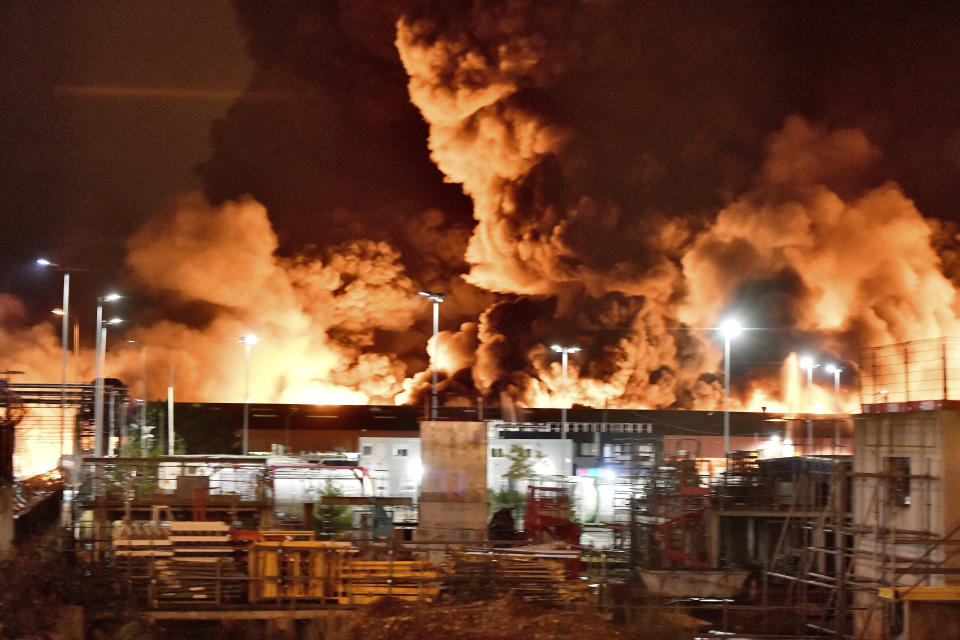 A fire is pictured at a chemical plant in Rouen, Normandy, Thursday, Sept.26, 2019. An immense mass of black smoke is rising over Normandy as firefighters battle a blaze at a chemical plant, and authorities closed schools in 11 surrounding towns and asked residents to stay indoors. (AP Photo/Stephanie Peron)