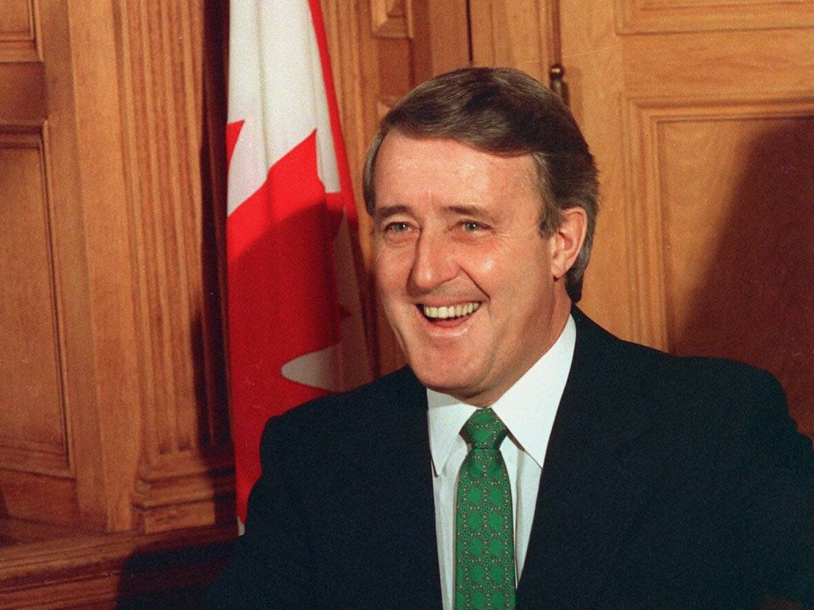 Prime Minister Brian Mulroney is all smiles before signing the proposed free trade agreement between Canada and the United States on Jan. 2, 1988. Mulroney, who died this week at 84, is remembered for his ability to foster personal relationships and free trade work.  (Fred Chartrand/The Canadian Press - image credit)