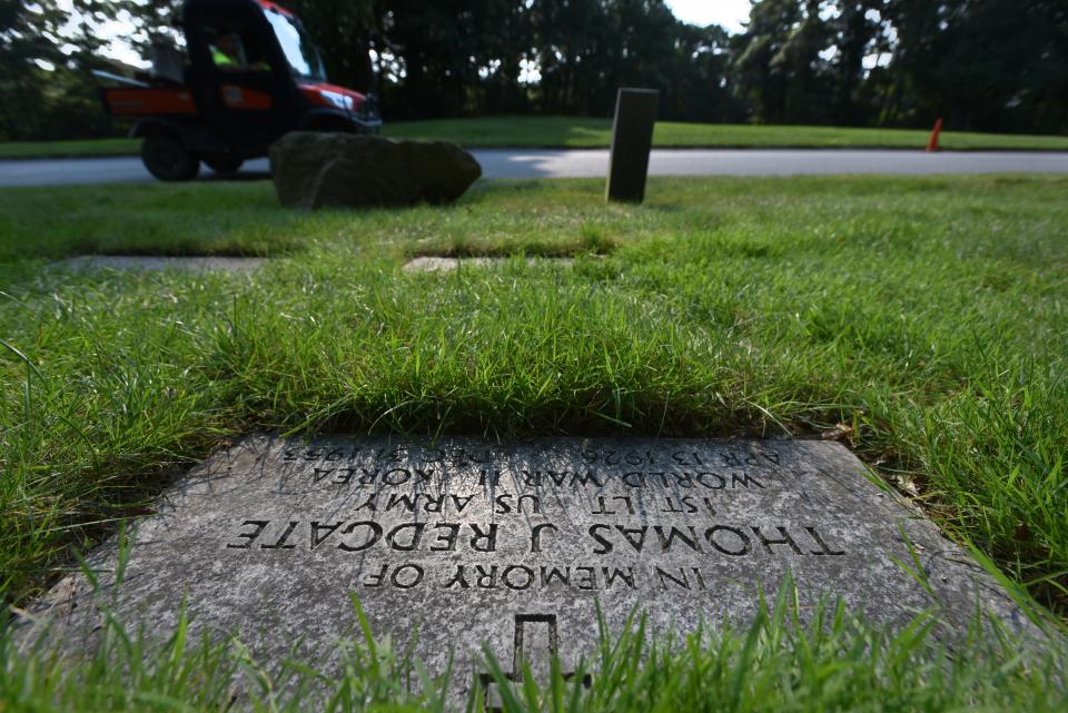 A memorial stone for Army Veteran Lt. Thomas Redgate catches the morning sun in a memorial area at the National Cemetery in Bourne, Massachusetts, for vets whose remains were never recovered. Redgate's remains were released from North Korea in 2020 and later identified by the Defense Department.