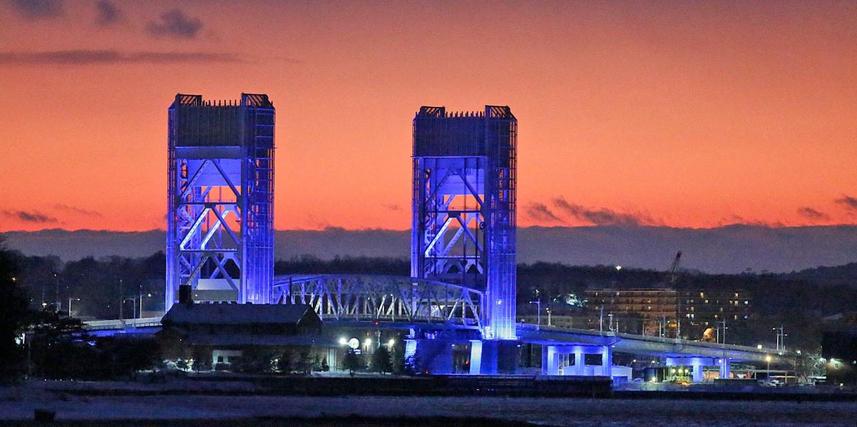 A dramatic orange sunset helps frame the Fore River Bridge, which connects Weymouth to Quincy, on Friday, Jan. 7, 2022.