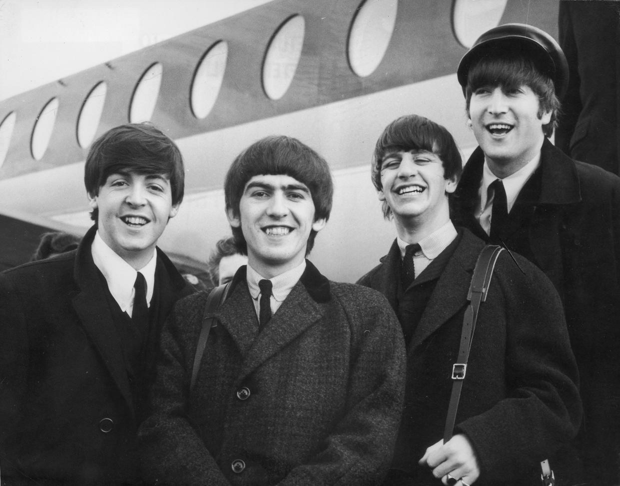 392279 03: (FILE PHOTO) The Beatles, left to right, Paul McCartney, George Harrison, Ringo Starr and John Lennon (1940 - 1980) arrive at London Airport February 6, 1964, after a trip to Paris. It was reported November 8, 2001 that Harrison is undergoing cancer treatment in a Staten Island, N.Y., hospital. The 58-year-old ex-Beatle was diagnosed with lung cancer and a brain tumor earlier this year. (Photo by Getty Images)