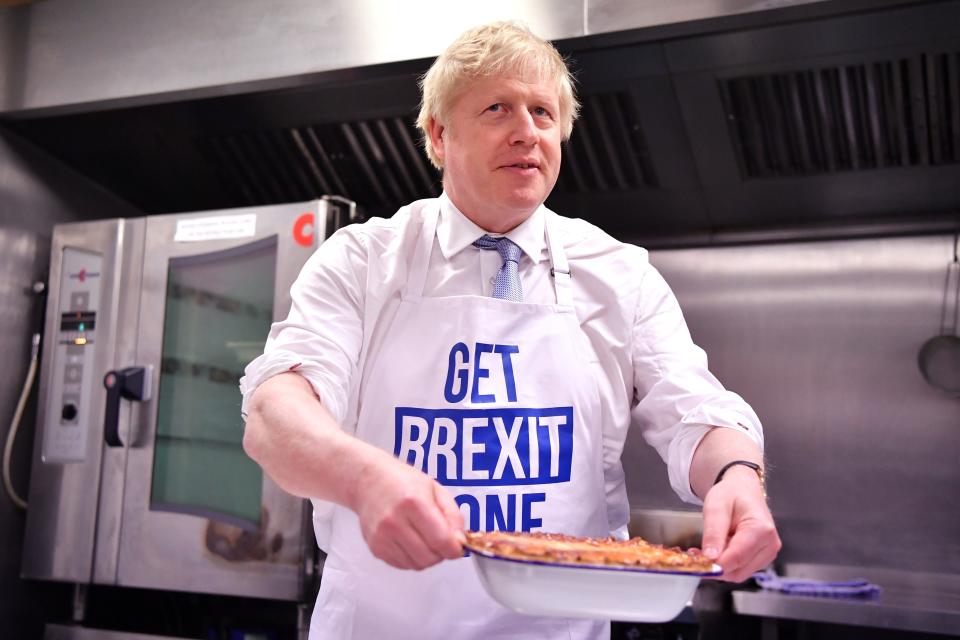 Britain's Prime Minister Boris Johnson prepares a pie at the Red Olive kitchen in Derby, England, on the final day of campaigning before a general election on Dec. 12, 2019.  in Derby, England.