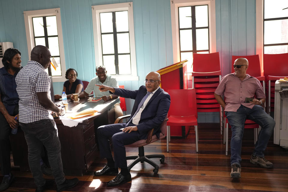 Guyana's Vice President Bharrat Jagdeo, who is a former president, jokes with supporters after giving a press conference at the Progressive People's Party headquarters in Georgetown, Guyana, Thursday, April 20, 2023. Jagdeo told AP that his party has created a special fund for oil revenues with safeguards to prevent corruption, including appointment of an independent monitor and a board of directors to oversee the fund along with the finance minister. (AP Photo/Matias Delacroix)