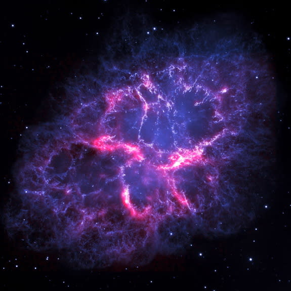 A composite image of the Crab Nebula. In blue are visible light observations from the Hubble Space Telescope, showing gas emissions caused by energy from a neutron star at the center of the nebula. In red are infrared observations from the Hers